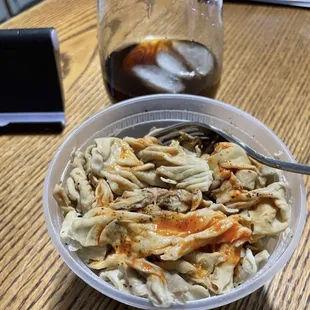a bowl of noodles and a drink