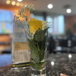 a vase of flowers on a counter