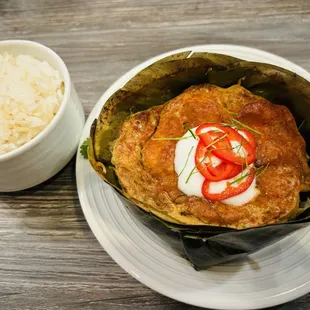 Amok (fresh fish fillets sliced and marinated lemongrass paste, sweet chili powder, and coconut cream. Baked in a hand-made banana leaf bowl