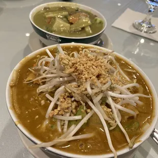 Red Curry Noodles (foreground) and Green Curry ...