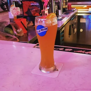 a pint of beer on a bar