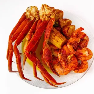 a plate of crab legs and potatoes