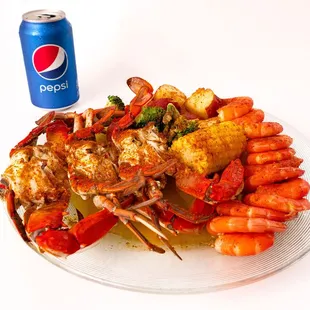 a plate of seafood and a can of pepsi