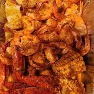 Healthy portion of shrimp, crab legs, potatoes and corn.  Finger lickin&apos; good!
