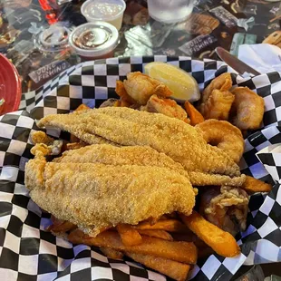 Fried catfish with shrimp, sweet potato fries and hush puppies.