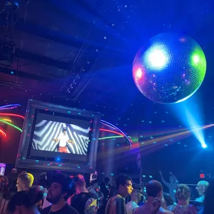 a crowd of people dancing at a nightclub