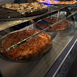 pizzas in a display case