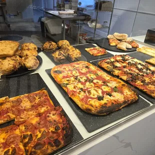 Selection of pizza, calzones, focaccia and pizza muffins