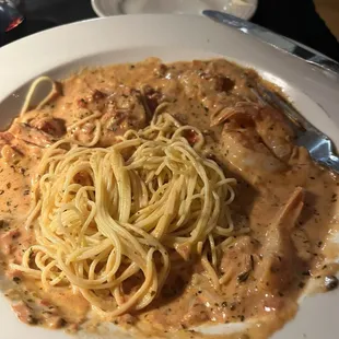 Shrimp in vodka sauce over angel hair pasta.