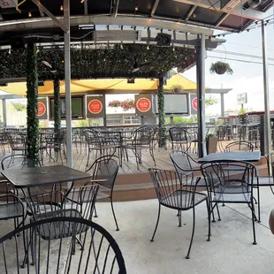 a patio with tables and chairs
