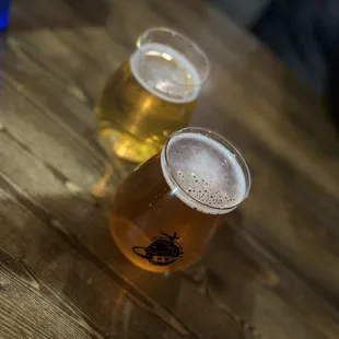 two glasses of beer on a wooden table