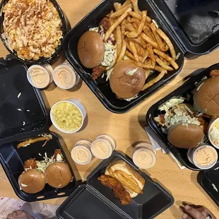 a table full of burgers and fries