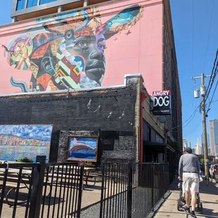 a man riding a bike in front of a building