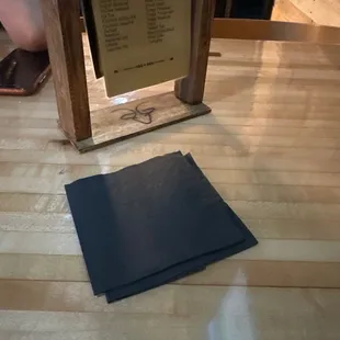 a menu on a wooden table
