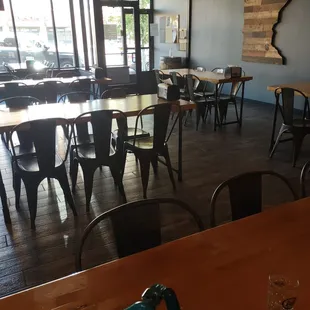 tap room w regular height tables &amp; lots of light from windowed store front