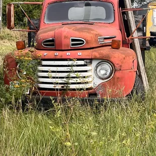 an old truck in a field