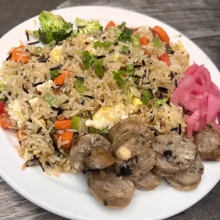 a plate of fried rice with mushrooms and broccoli