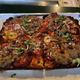 a square pizza on a tray