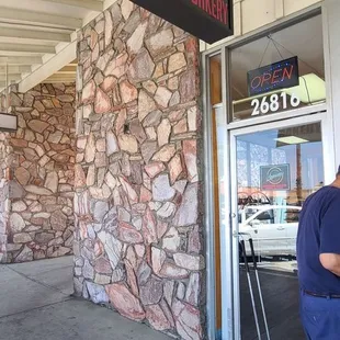 a man standing in front of a store