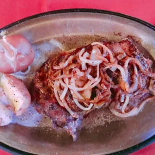 a plate of meat and onions
