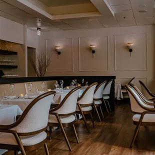 a dining room with white tablecloths and chairs