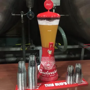 a drink dispenser with a beer in it
