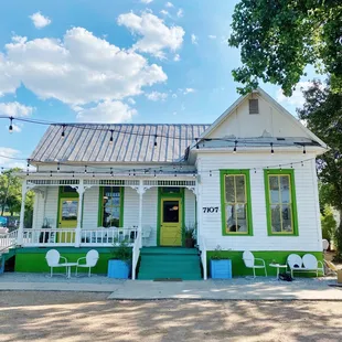 a white house with green shutters