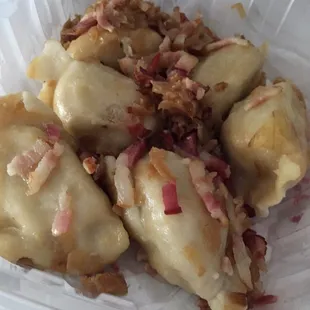 Pork &amp; beef pierogis topped with bacon