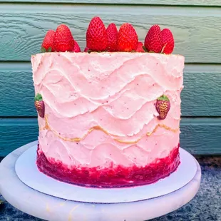 A vanilla cake with strawberry Russian buttercream, strawberry preserves and fresh strawberries