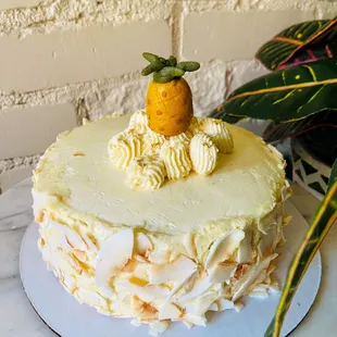 A vegan coconut cake with coconut buttercream and a marzipan pineapple. To die for.