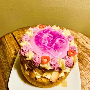A valentine cake. Coconut base with coconut and ube Russian buttercream and ube panna cotta. Made for The Howling Wolf bar.