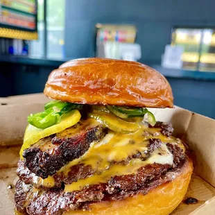 Wow their burger. I did double patties + pork belly + jalapeños + gold sauce.