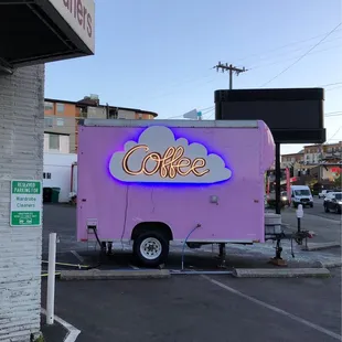 a coffee truck parked in front of a coffee shop