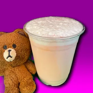 a teddy bear next to a cup of coffee