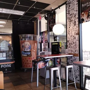 Inside Anime cafe, pinball machine, decorations.