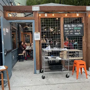 the outside of a restaurant with tables and chairs