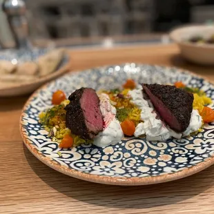 Hawaij-Spiced Shortrib served with labneh, saffron rice, pistachios, and kumquats