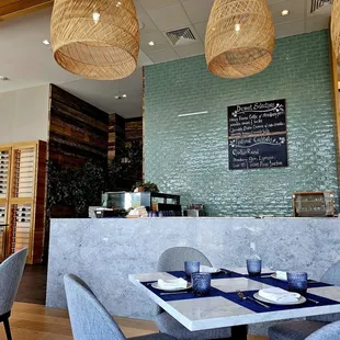 a dining area with a table and chairs