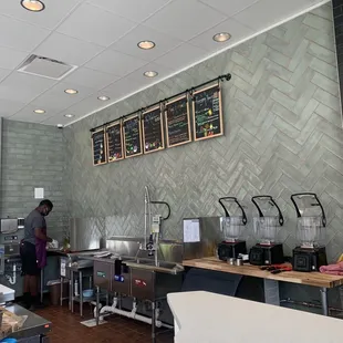 a restaurant with a counter and a menu on the wall