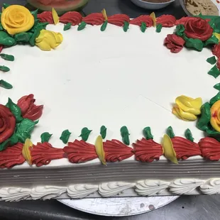 a cake decorated with red and yellow roses