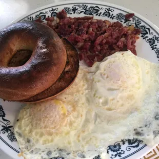 Corned Beef Hash with two eggs over easy and a bagel.