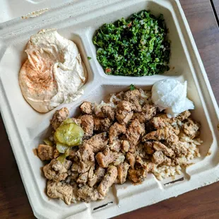 Chicken shawarma bowl with rice, hummus, tabbouleh, and garlic paste. So good.