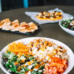 Buffalo Blue Bowl - Chicken breast, brown rice, mixed greens, tomatoes, carrots, blue cheese, creamy feta, zip sauce. (gluten-free, halal)