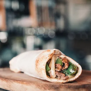 The 'Ferndale Philly' features marinated beef, green peppers, and onions, with shredded mozzarella and provolone cheese. (soy-free, halal)