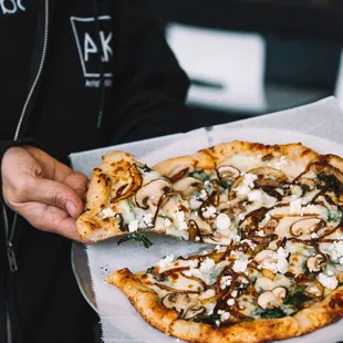 Check out The Forager Flatbread, featuring cremini mushrooms, caramelized onions, spinach, garlic, mozzarella, provolone, and feta cheese.