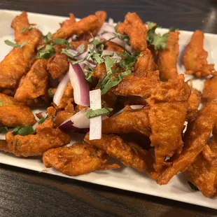 a plate of deep fried chicken wings