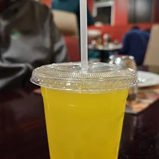 a drink in a plastic cup with a straw