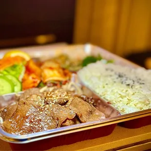 Yakiniku Beef bento box (bbq beef, sautéed bean sprouts, rice, salad, Home Made Kimchi, 2 types of japchae, &amp; sautéed spinach.)