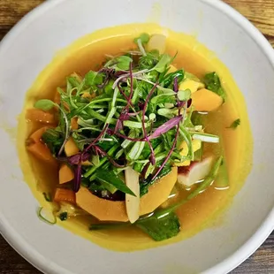 a bowl of food on a wooden table