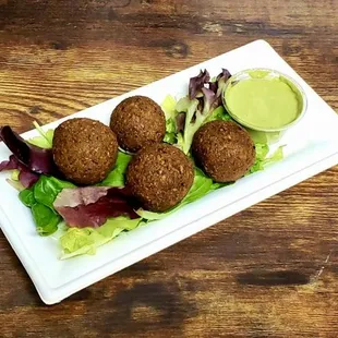 a plate of falafes and lettuce